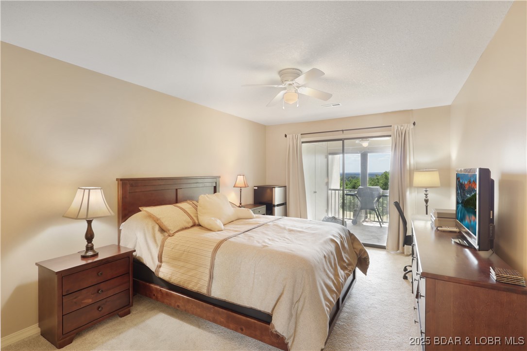 24 East Casa Del Rio, Unit 689 Lake Ozark, MO 65049 - Photo 24 of 31 Guest bedroom with access to back deck.