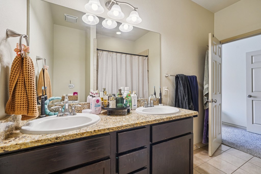2312 Sailing Way Kerrville, TX 78028 - Photo 34 of 60 a bathroom with a granite countertop sink and a mirror