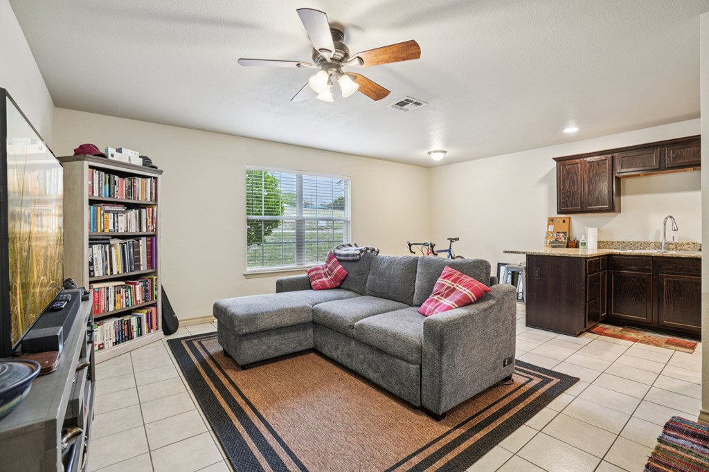 2312 Sailing Way Kerrville, TX 78028 - Photo 5 of 60 a living room with furniture and a book shelf