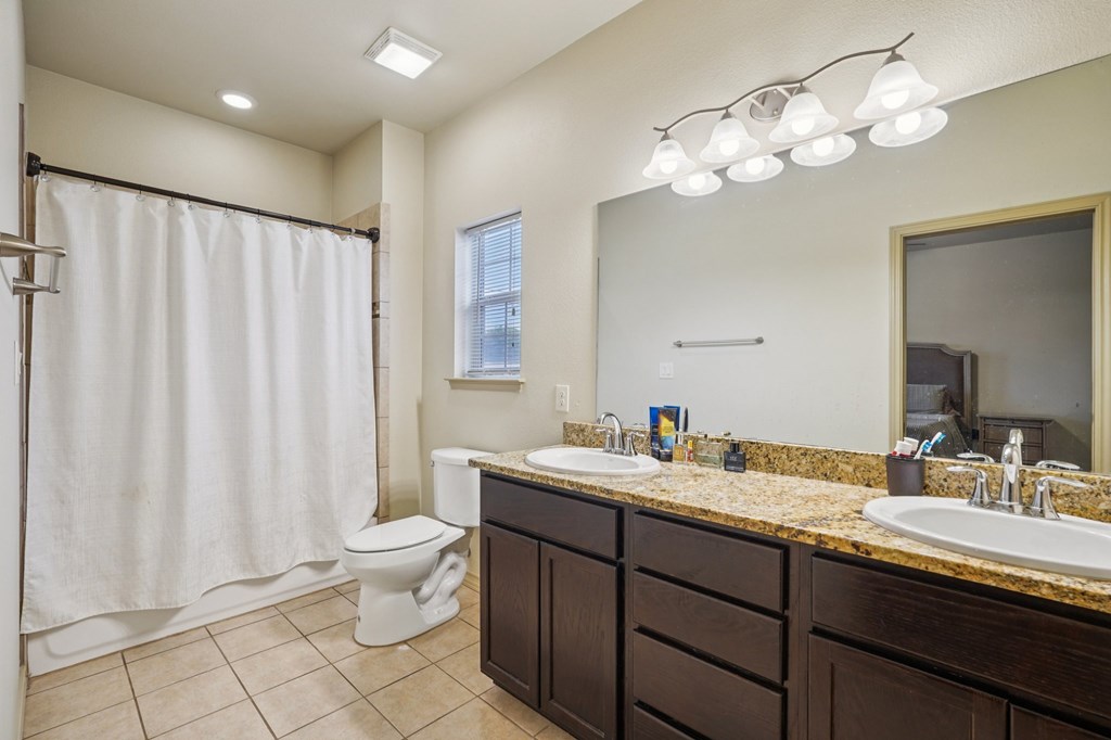 2312 Sailing Way Kerrville, TX 78028 - Photo 55 of 60 a bathroom with a double vanity sink mirror and toilet