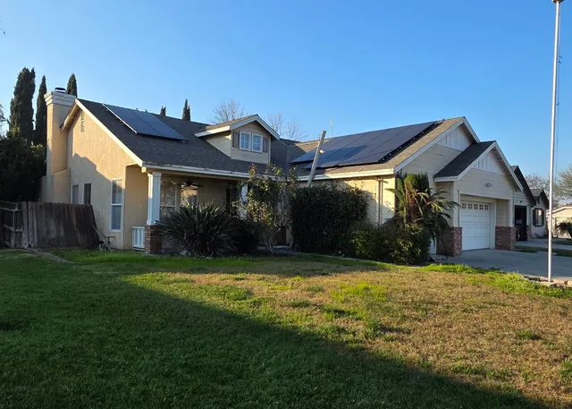 a view of a house with a yard and a porch