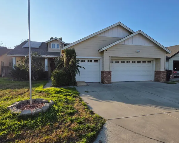 a front view of a house with a yard