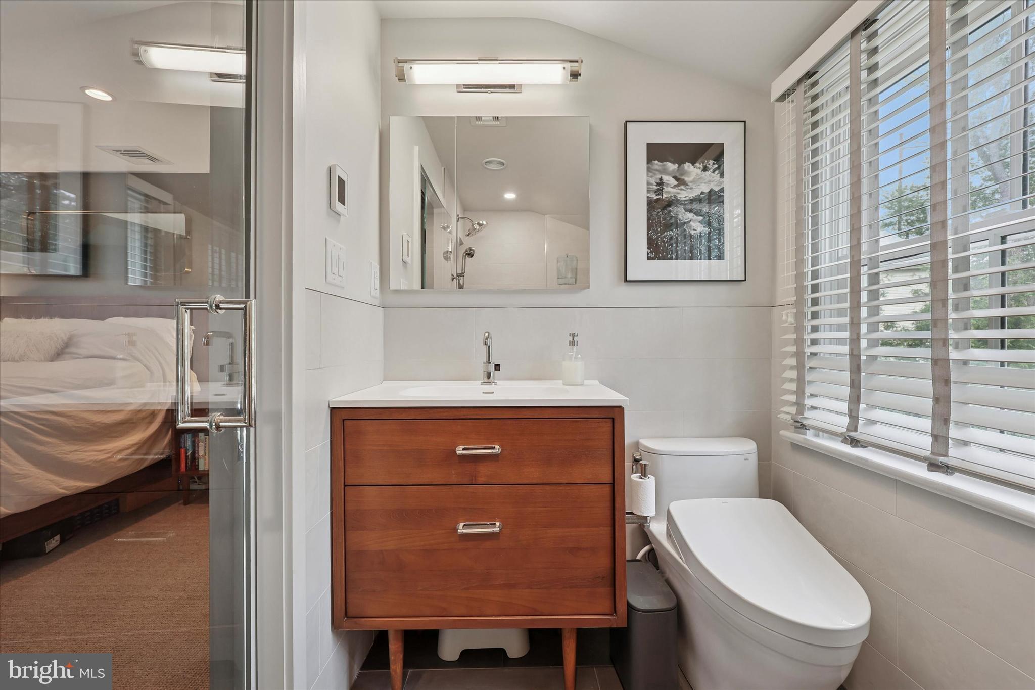 160 Rolling Road Bala Cynwyd, PA 19004 - Photo 20 of 35 a bathroom with a toilet a sink and mirror