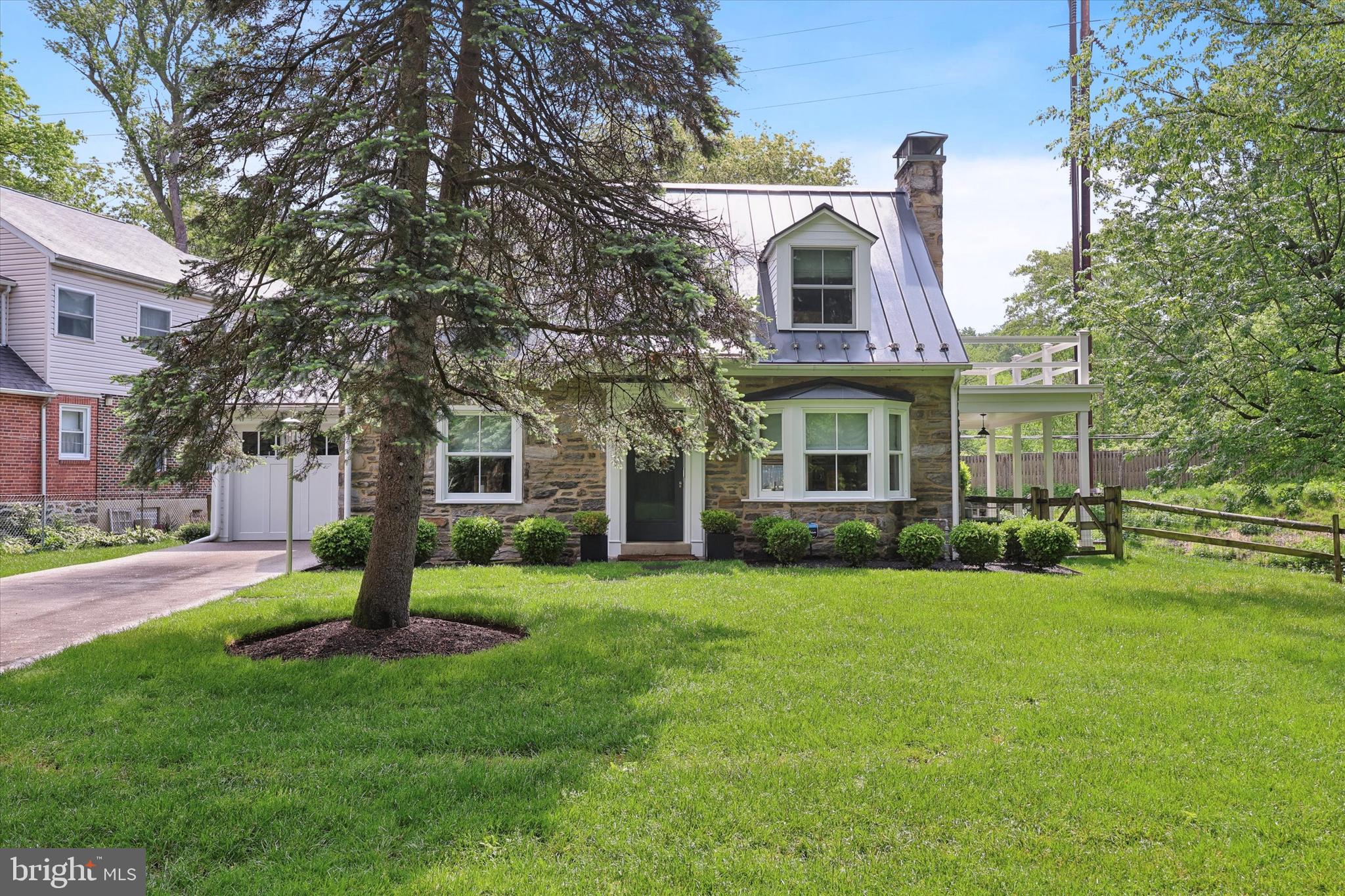 160 Rolling Road Bala Cynwyd, PA 19004 - Photo 2 of 35 a front view of a house with a garden