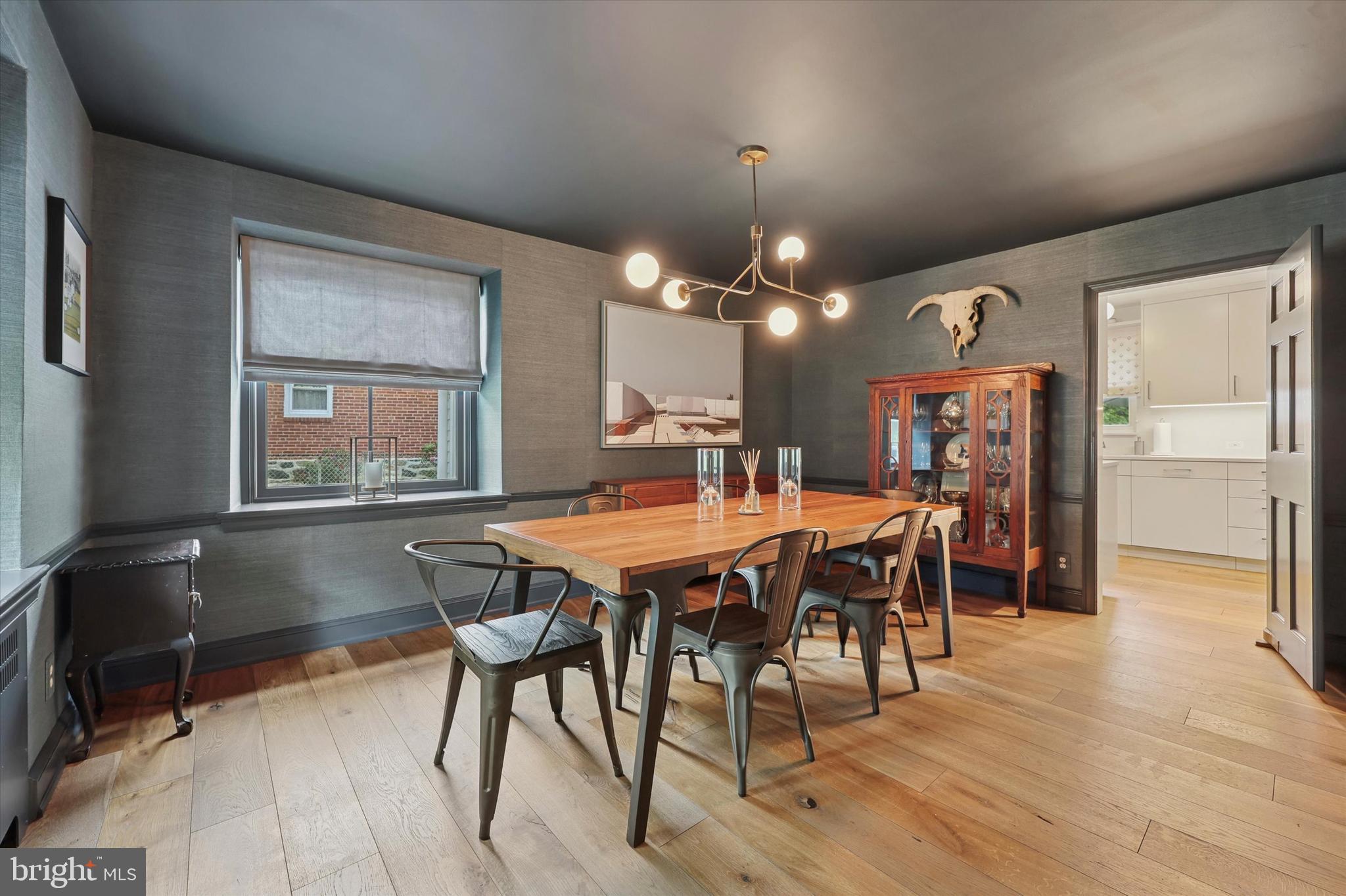 160 Rolling Road Bala Cynwyd, PA 19004 - Photo 6 of 35 a dining room with wooden floor a chandelier a wooden table and chairs