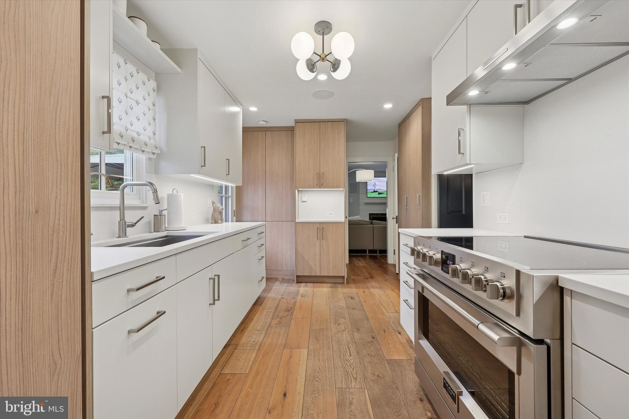 160 Rolling Road Bala Cynwyd, PA 19004 - Photo 10 of 35 a large kitchen with stainless steel appliances granite countertop a large stove a sink dishwasher and a refrigerator with wooden floor