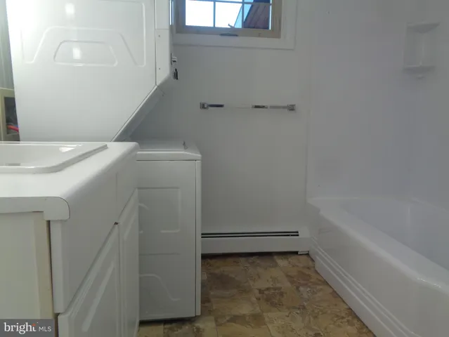 a bathroom with a tub and sink