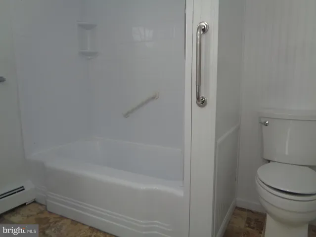 a bathroom with a shower and a toilet