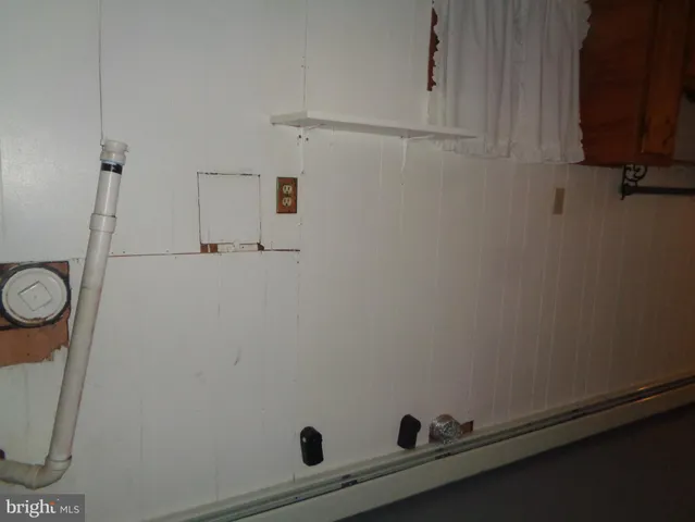 a view of a storage and utility room with racks on the wall