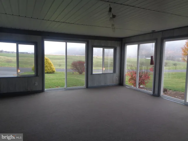 a view of room with balcony and floor to ceiling window