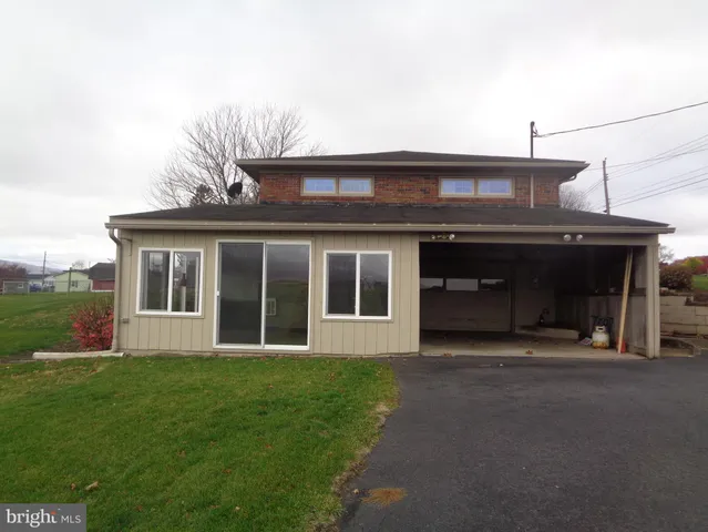 a front view of a house with a garden and yard