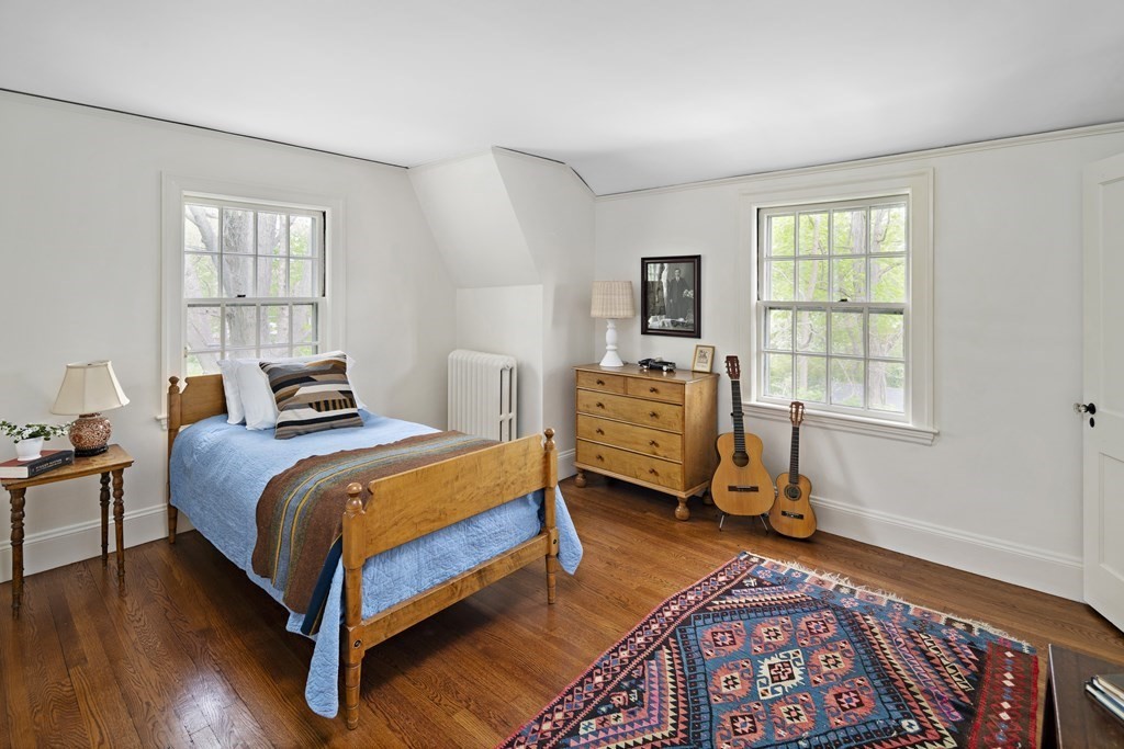 112 Bailey Road Watertown, MA 02472 - Photo 27 of 34 a bedroom with a bed and wooden floor