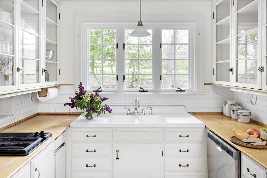 112 Bailey Road Watertown, MA 02472 - Photo 9 of 34 a kitchen with granite countertop a sink stove and window