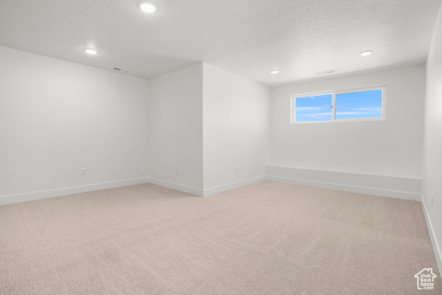 1631 West Century Lane, Unit B Mapleton, UT 84664 - Photo 23 of 33 Spare room with light colored carpet, a textured ceiling, and recessed lighting