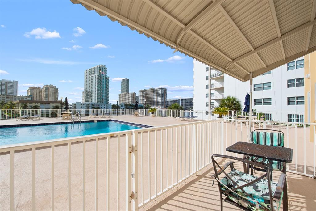 111 Golden Isles Drive, Unit B2 Hallandale Beach, FL 33009 - Photo 12 of 12 a view of balcony with wooden floor
