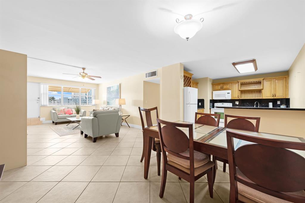 111 Golden Isles Drive, Unit B2 Hallandale Beach, FL 33009 - Photo 2 of 12 a view of a dining room with furniture and a chandelier