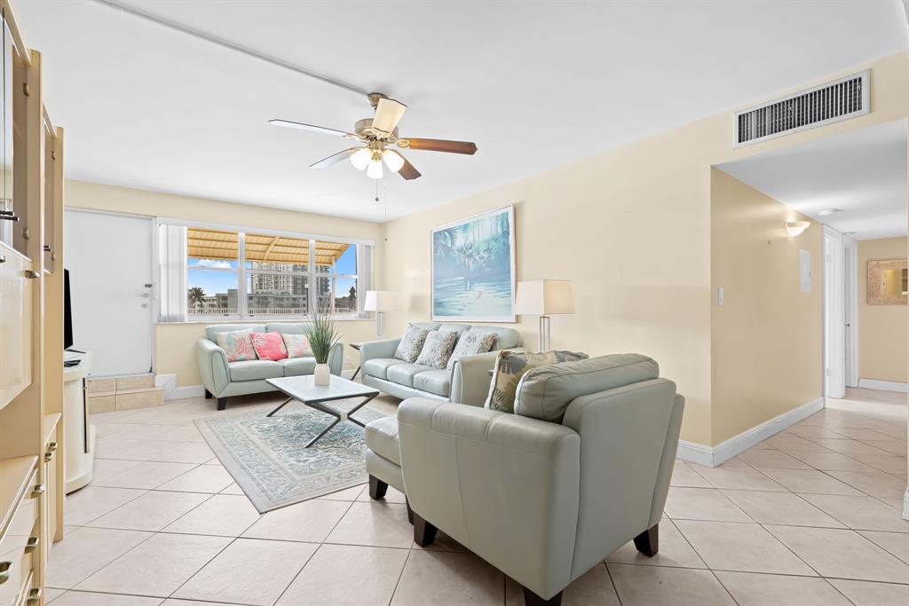 111 Golden Isles Drive, Unit B2 Hallandale Beach, FL 33009 - Photo 3 of 12 a living room with furniture and a large window