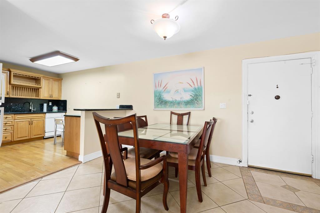 111 Golden Isles Drive, Unit B2 Hallandale Beach, FL 33009 - Photo 5 of 12 a view of a dining room with furniture