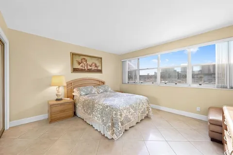 a bedroom with a bed and glass window