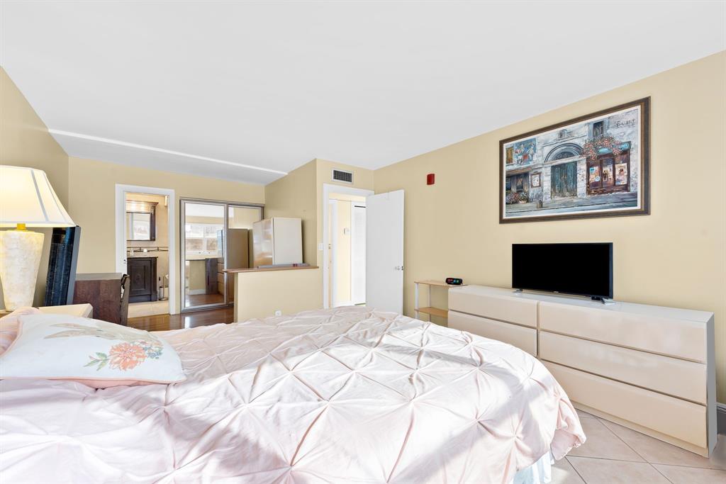 111 Golden Isles Drive, Unit B2 Hallandale Beach, FL 33009 - Photo 9 of 12 a bedroom with a large bed and a large bed