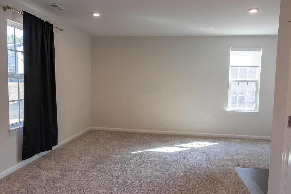 4847 Randall Road Durham, NC 27707 - Photo 18 of 25 an empty room with windows