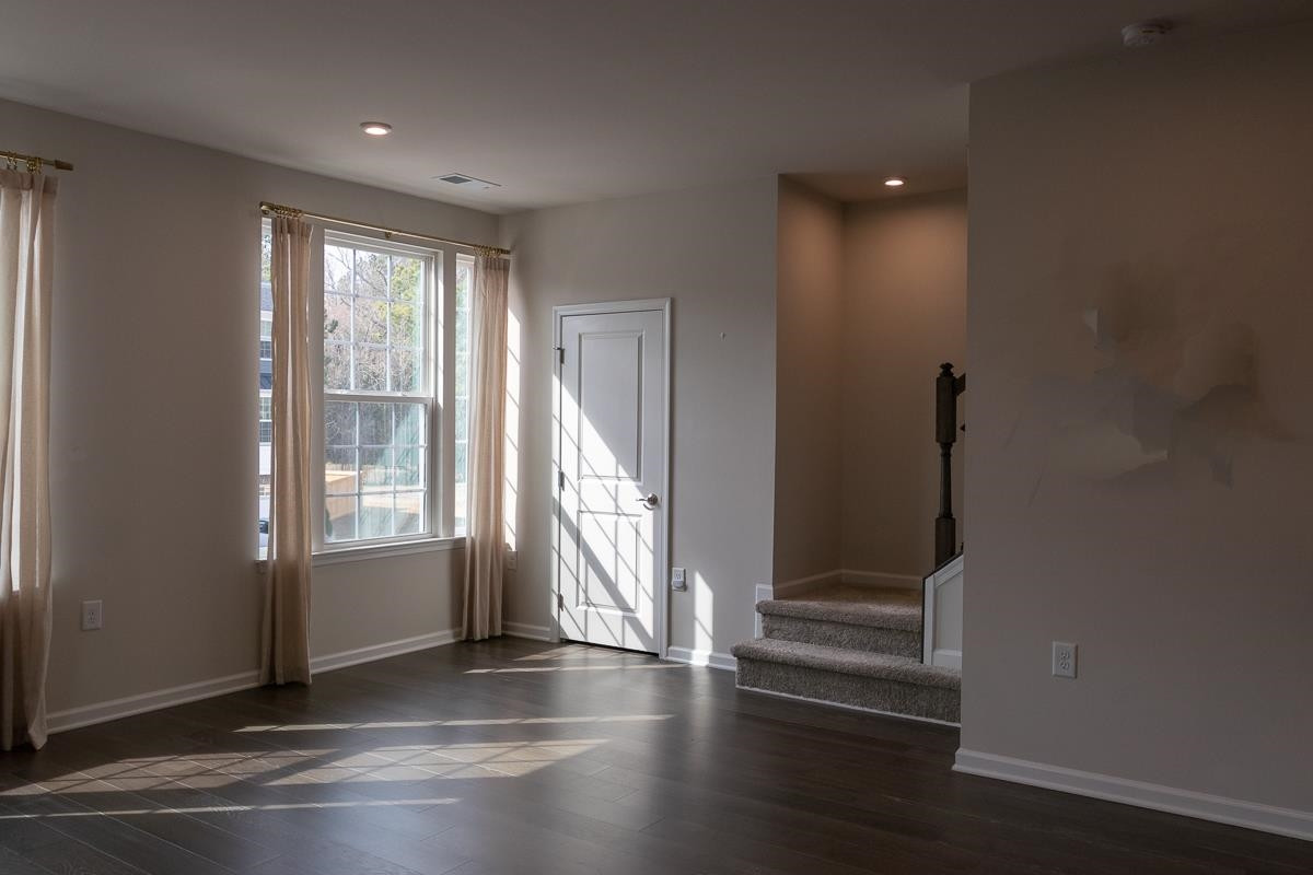 4847 Randall Road Durham, NC 27707 - Photo 3 of 25 an empty room with wooden floor and windows