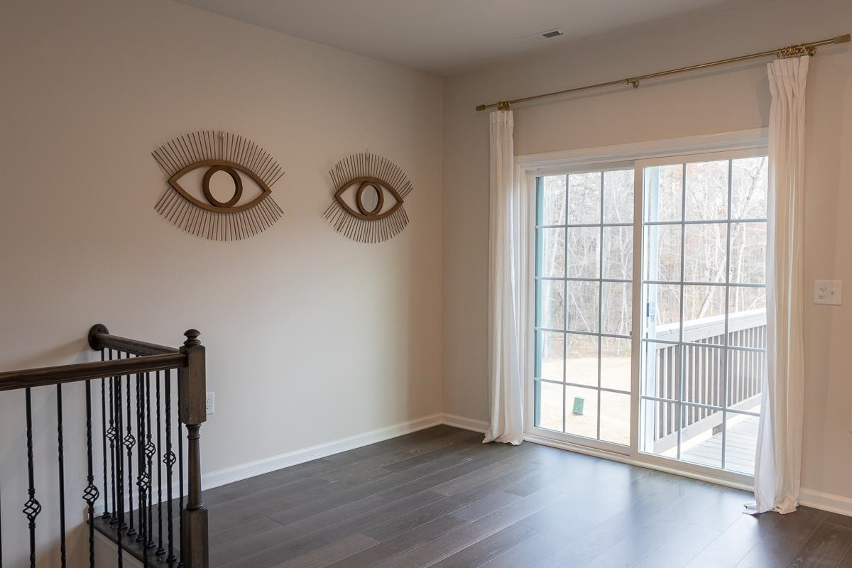 4847 Randall Road Durham, NC 27707 - Photo 8 of 25 an empty room with wooden floor and windows