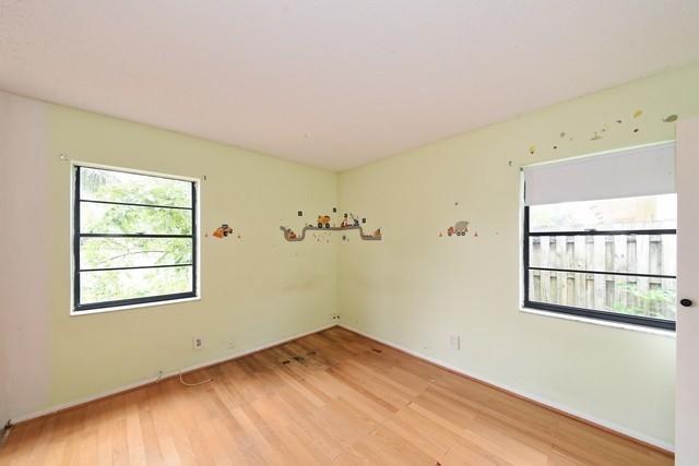 9774 Richmond Circle Boca Raton, FL 33434 - Photo 11 of 14 a view of empty room with wooden floor and fan