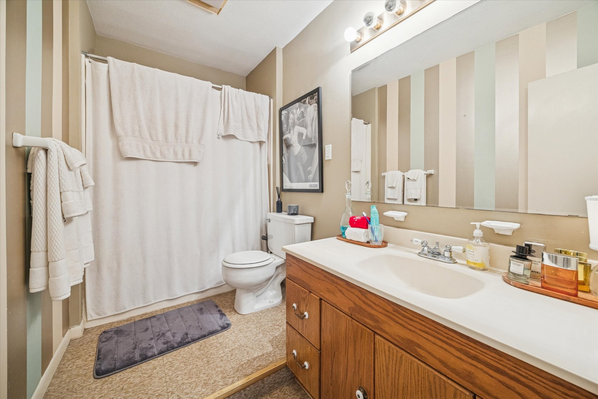 3711 Reagan Street Houston, TX 77009 - Photo 12 of 40 a bathroom with a sink a toilet and a large mirror