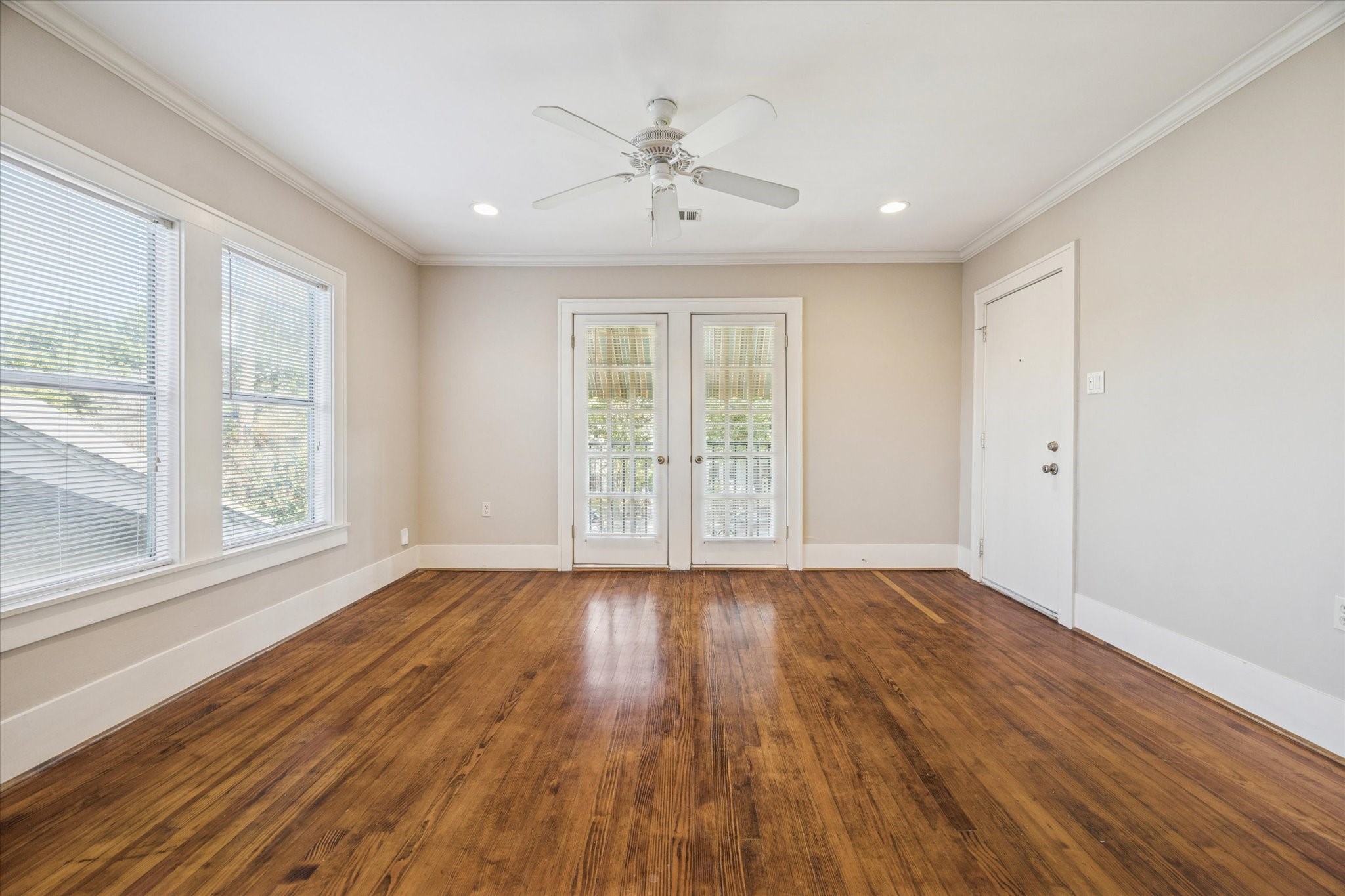 3711 Reagan Street Houston, TX 77009 - Photo 14 of 40 a view of an empty room with wooden floor and a window