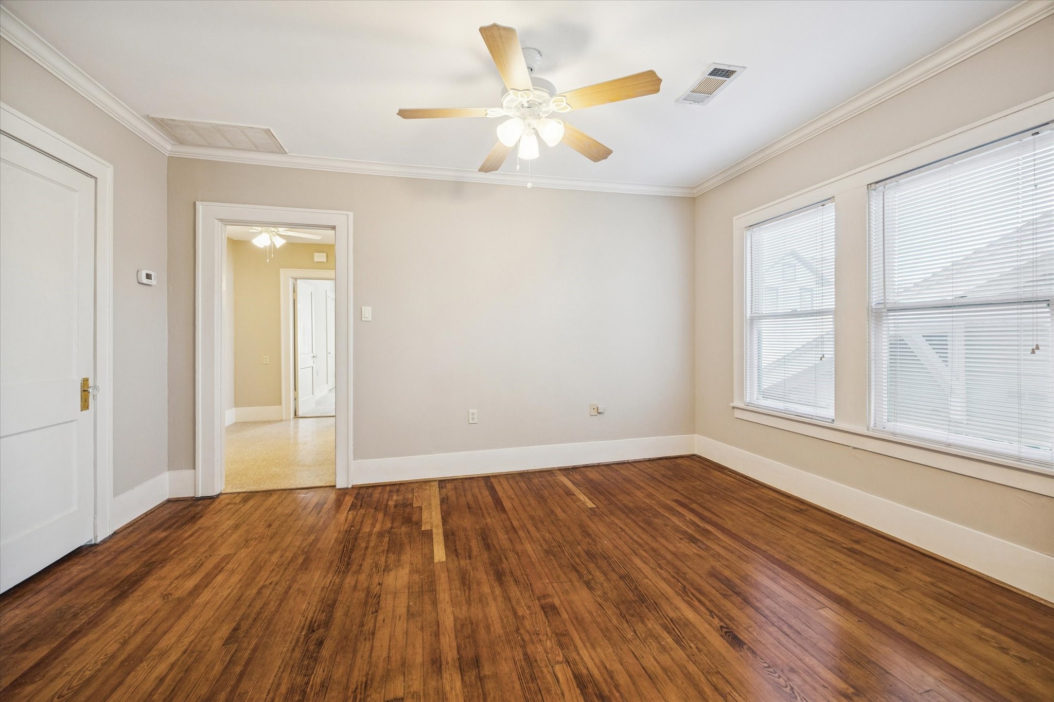 3711 Reagan Street Houston, TX 77009 - Photo 15 of 40 a view of an empty room with wooden floor and a window