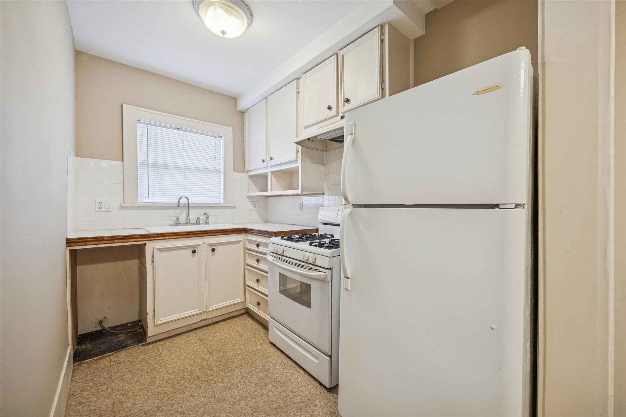 3711 Reagan Street Houston, TX 77009 - Photo 17 of 40 a kitchen with a refrigerator sink stove and cabinets