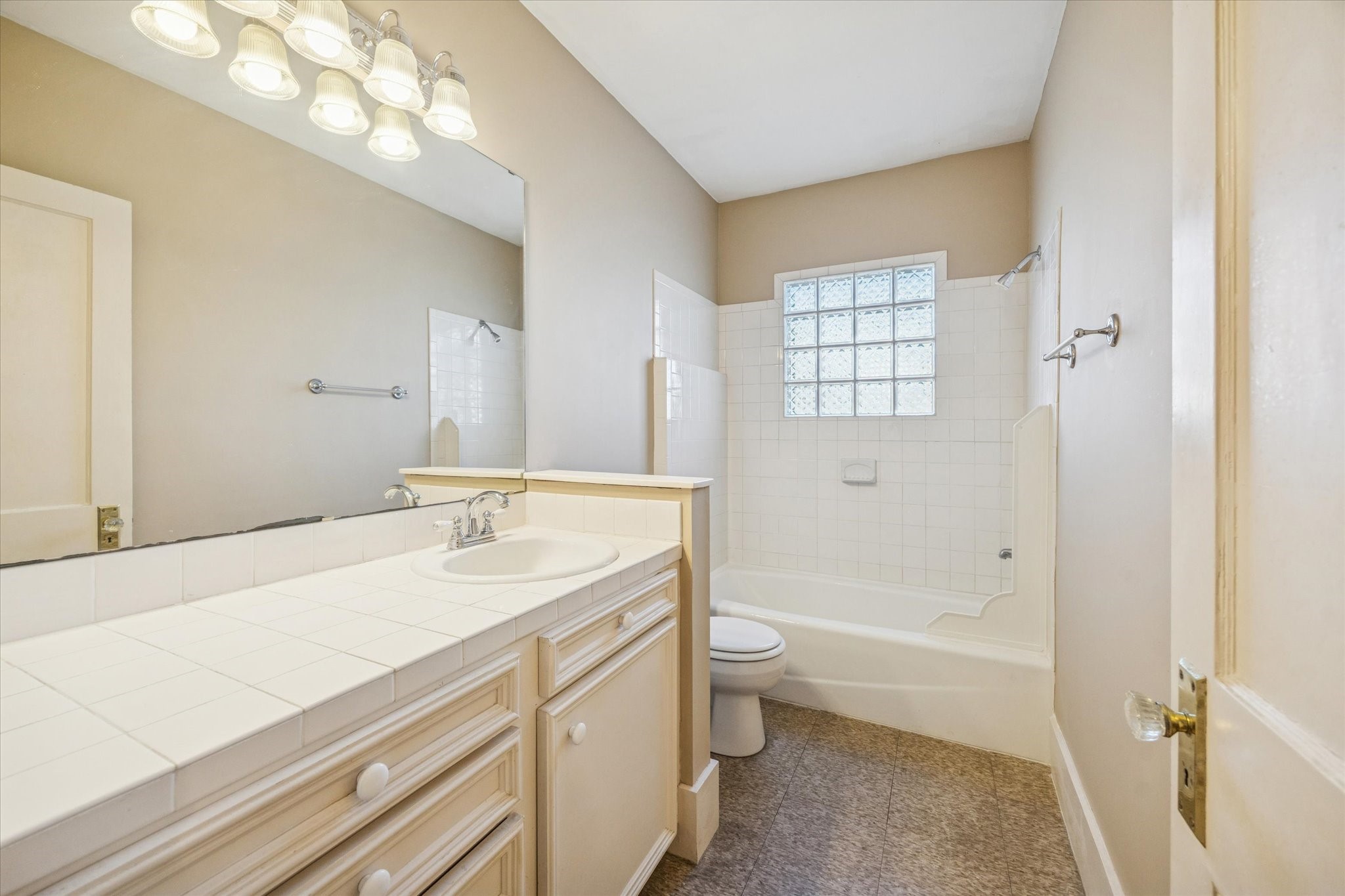 3711 Reagan Street Houston, TX 77009 - Photo 20 of 40 a bathroom with a granite countertop sink a toilet and shower