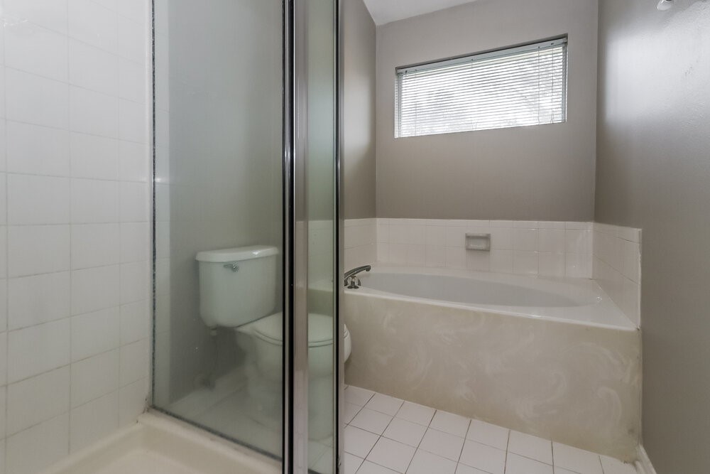 19823 Indian Cherry Forest Lane Cypress, TX 77433 - Photo 12 of 16 a bathroom with a bathtub and toilet