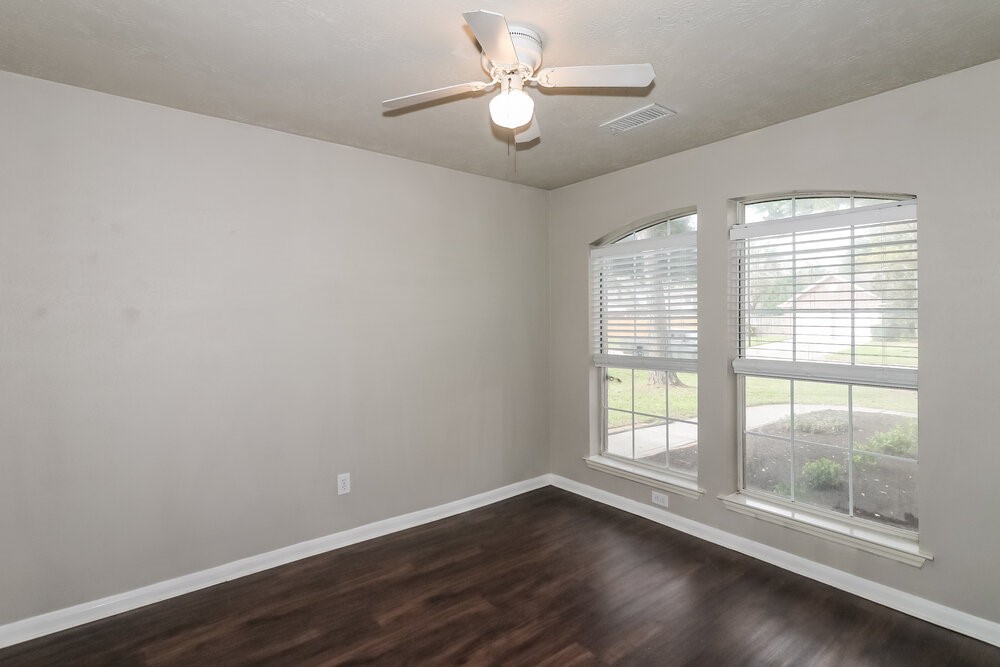 19823 Indian Cherry Forest Lane Cypress, TX 77433 - Photo 14 of 16 a view of an empty room with wooden floor and a window
