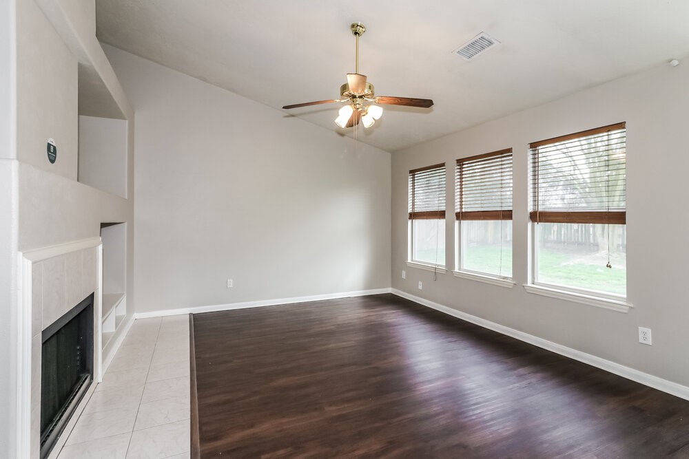 19823 Indian Cherry Forest Lane Cypress, TX 77433 - Photo 5 of 16 a view of an empty room with wooden floor and a window