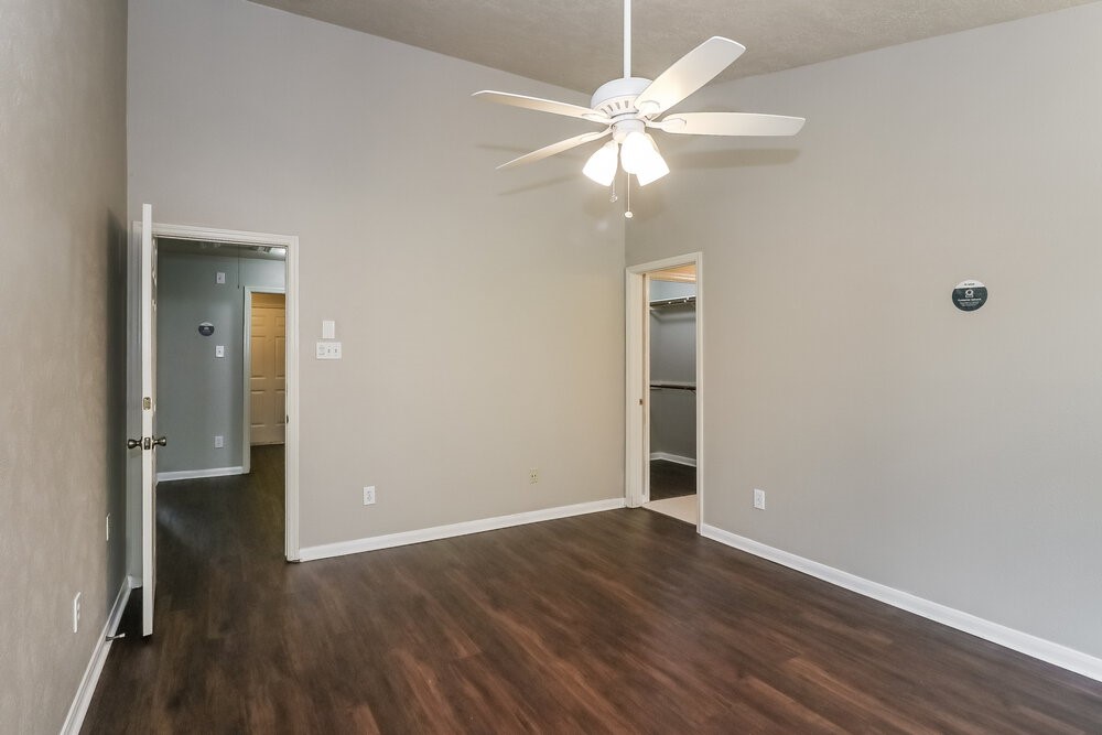 19823 Indian Cherry Forest Lane Cypress, TX 77433 - Photo 10 of 16 an empty room with wooden floor fan and windows