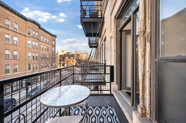 a view of a balcony with furniture