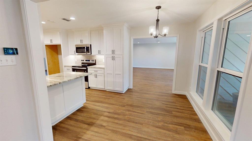 1110 Mill Run Road Athens, TX 75751 - Photo 5 of 32 a kitchen with stainless steel appliances a refrigerator and a stove top oven