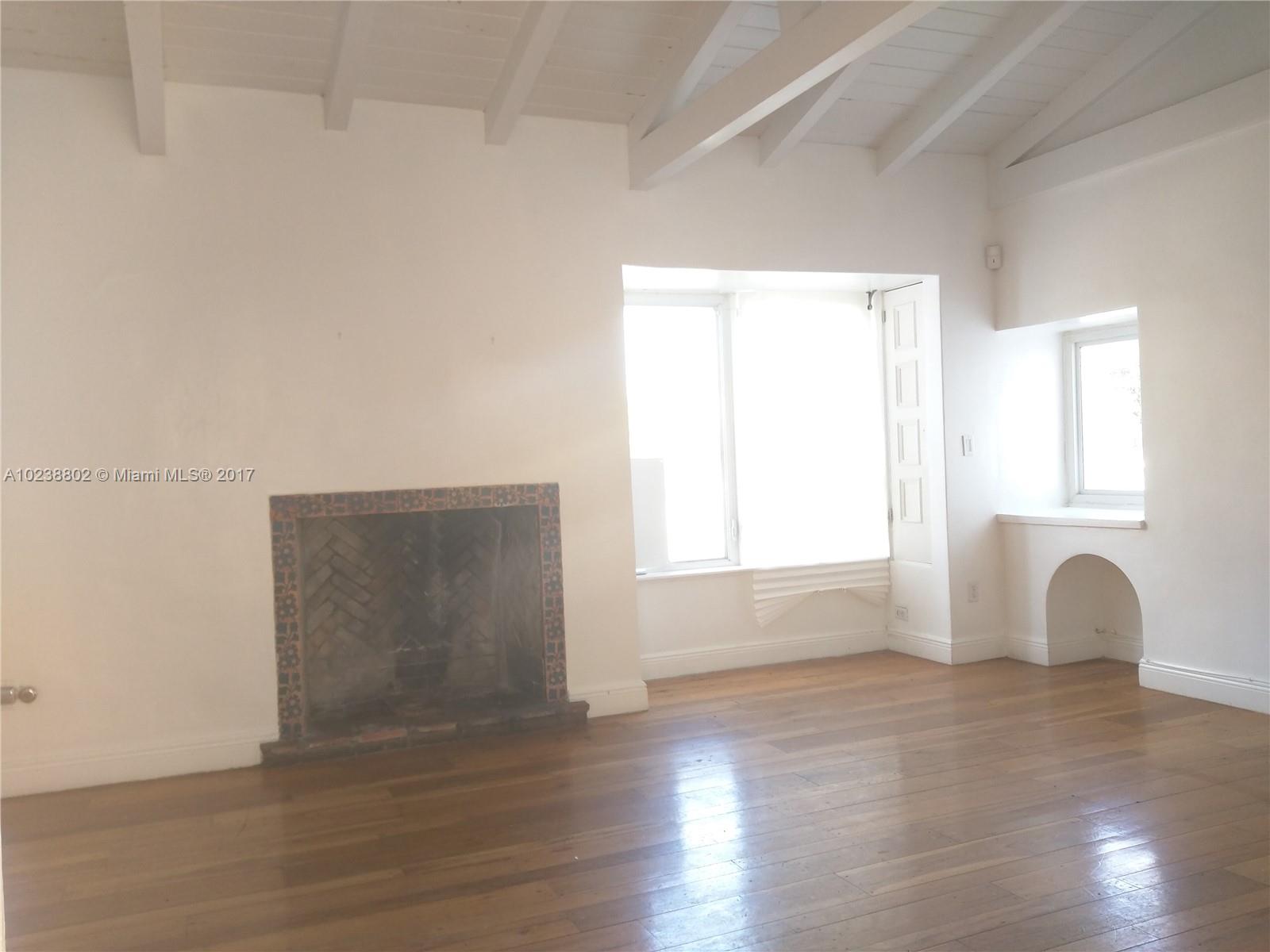 4717 Alton Road Miami Beach, FL 33140 - Photo 30 of 34 a view of an empty room with wooden floor and window