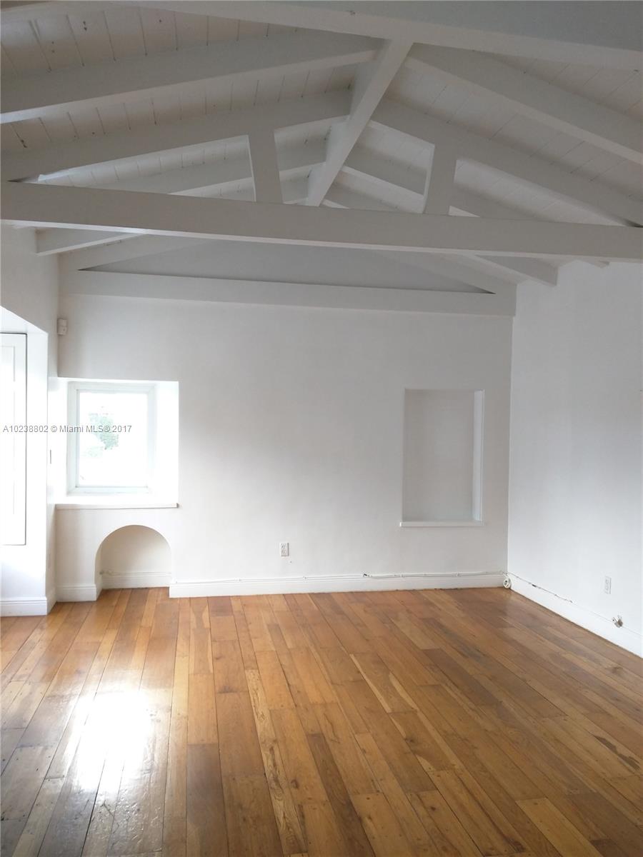 4717 Alton Road Miami Beach, FL 33140 - Photo 3 of 34 a view of wooden floor and windows in a room