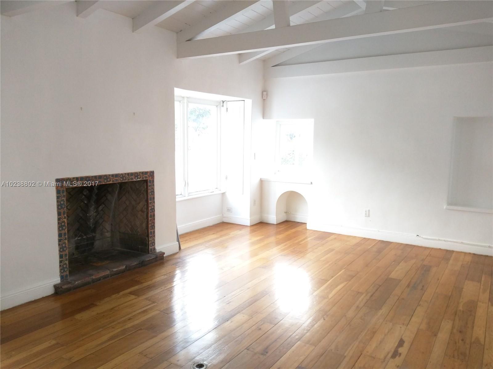 4717 Alton Road Miami Beach, FL 33140 - Photo 4 of 34 a view of empty room with wooden floor and fan