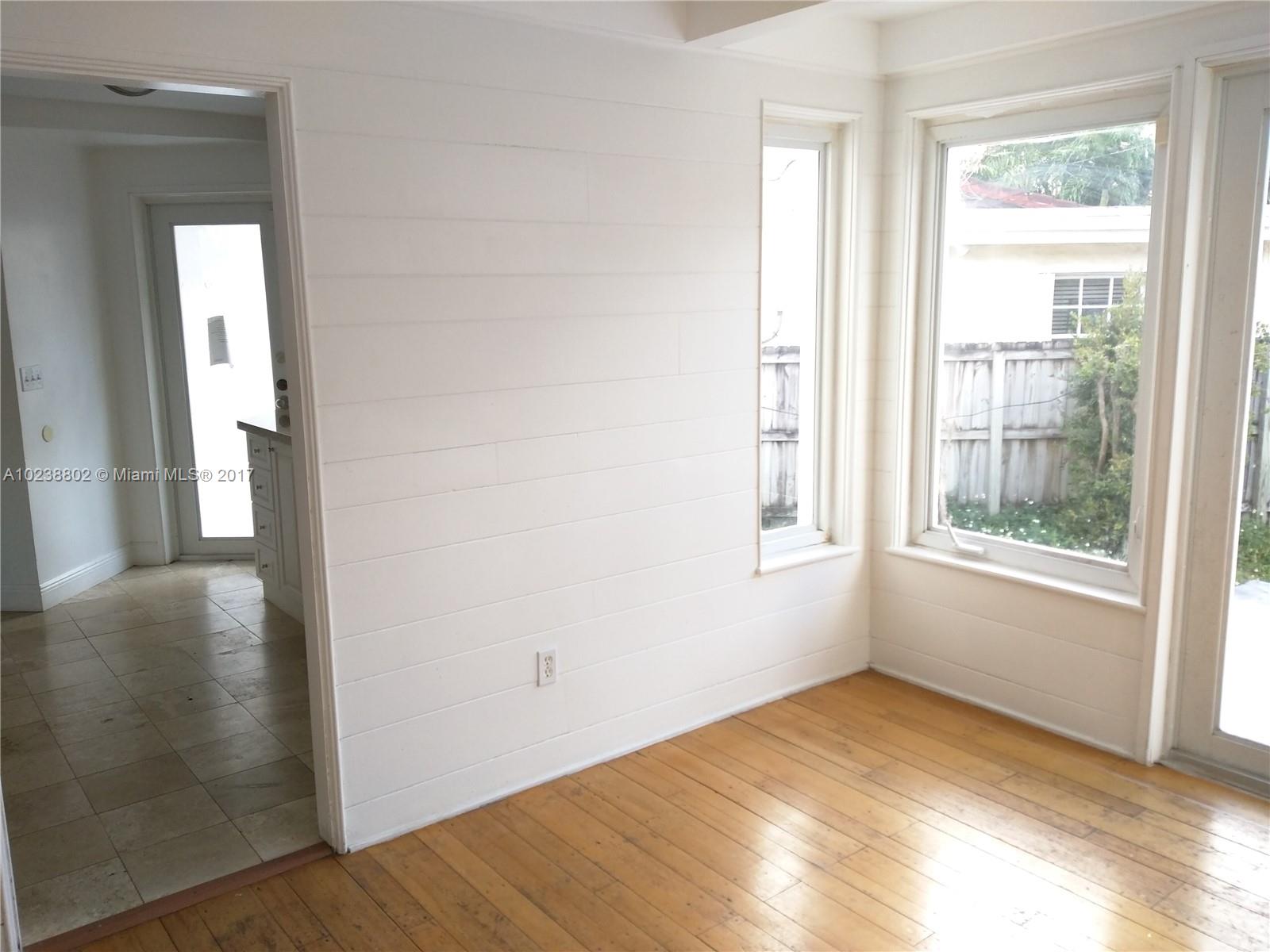 4717 Alton Road Miami Beach, FL 33140 - Photo 5 of 34 a view of empty room with wooden floor and fan