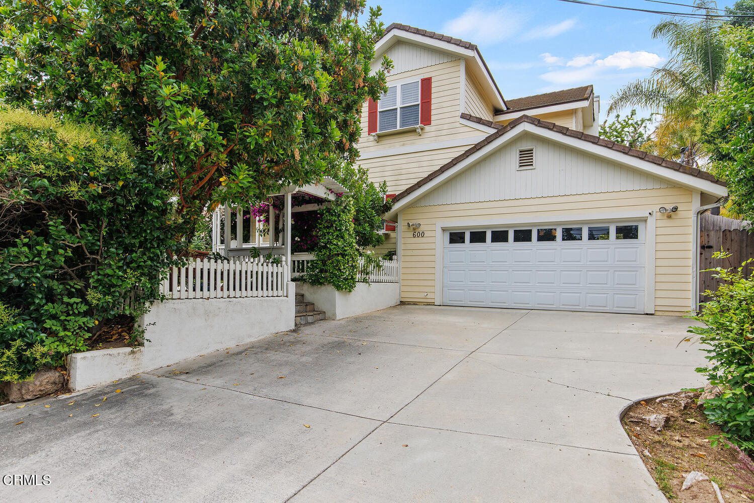 600 Rancho Road Thousand Oaks, CA 91362 - Photo 2 of 47 a view of a white house with large windows and a small yard