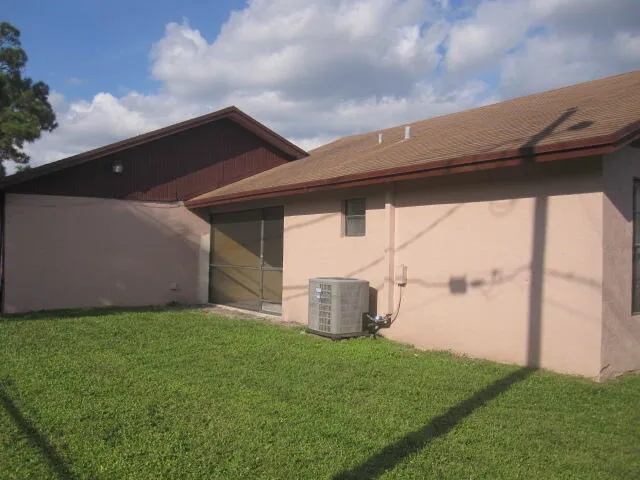 a backyard of a house with lots of green space and plants