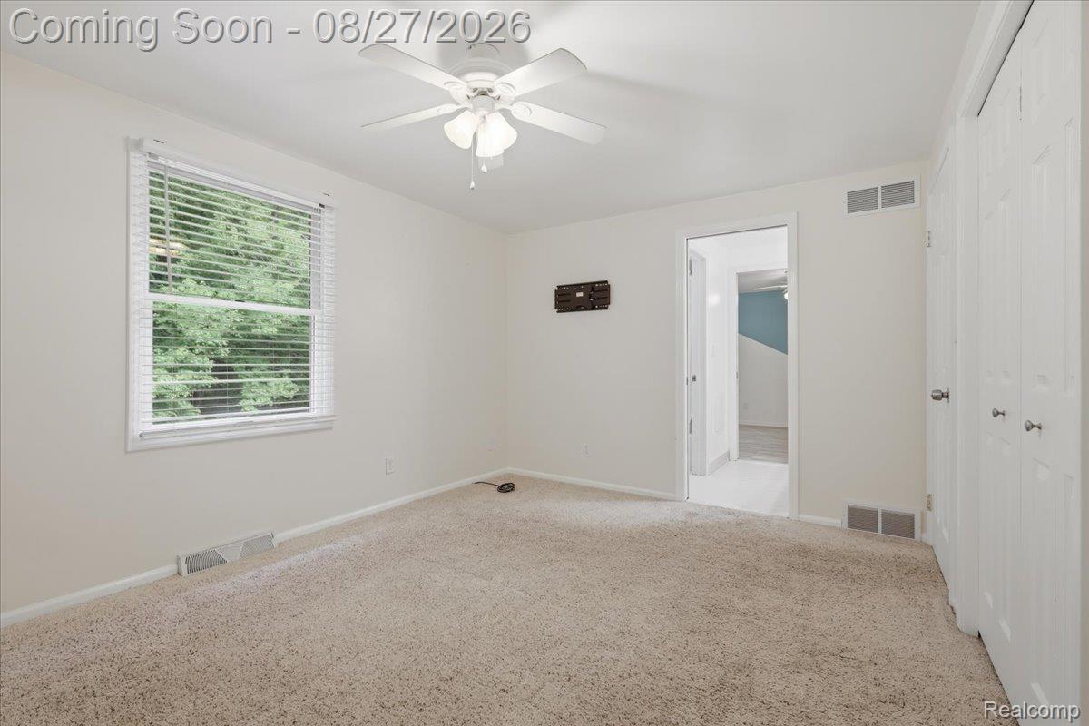 10100 Springtime Circle Clarkston, MI 48348 - Photo 44 of 73 Neutral wall color, ceiling fan, window with blinds, and carpeted flooring