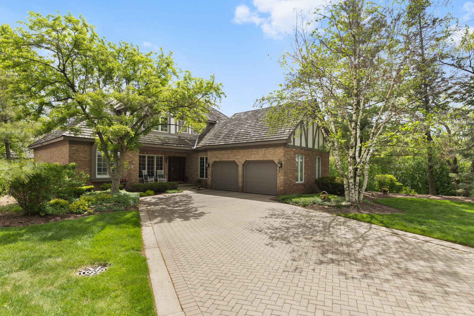 20 Lake Ridge Club Court Burr Ridge, IL 60527 - Photo 1 of 43 a front view of a house with a garden and trees