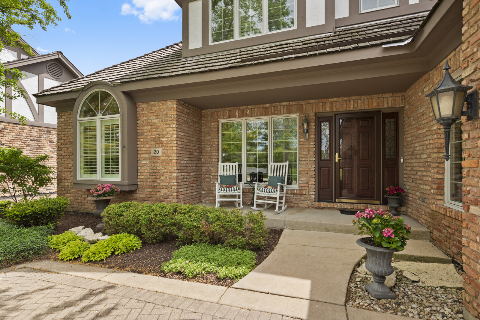 20 Lake Ridge Club Court Burr Ridge, IL 60527 - Photo 2 of 43 a front view of a house with a garden and plants