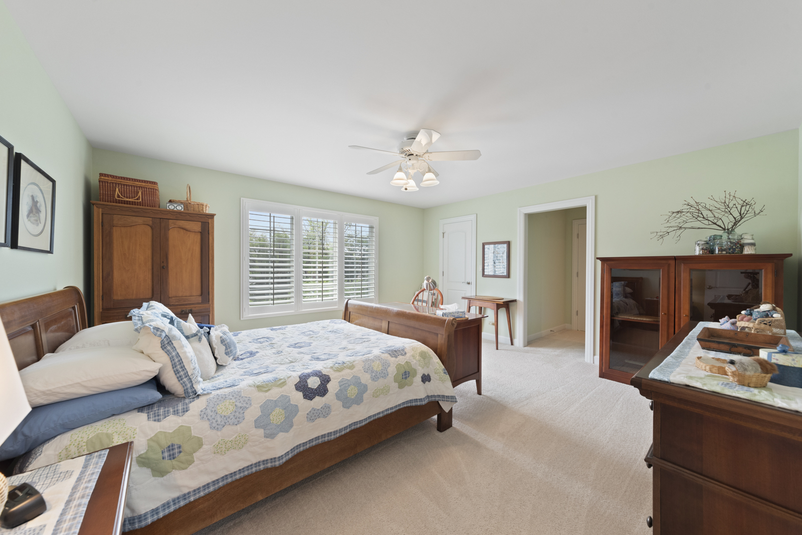 20 Lake Ridge Club Court Burr Ridge, IL 60527 - Photo 23 of 43 a bedroom with a bed and a chandelier