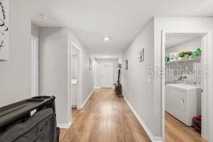 11014 Golden Warbler Road Brooksville, FL 34613 - Photo 15 of 50 a view of a hallway with wooden floor and a living room